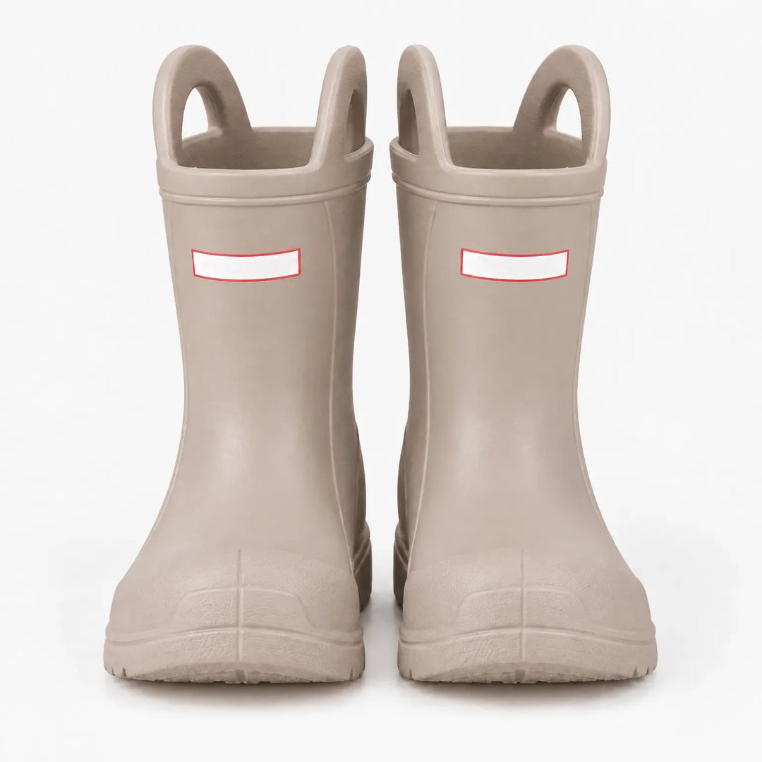 Front view of a pair of beige wellies with pull-on handles and toe caps, studio shot on a white background. 7
