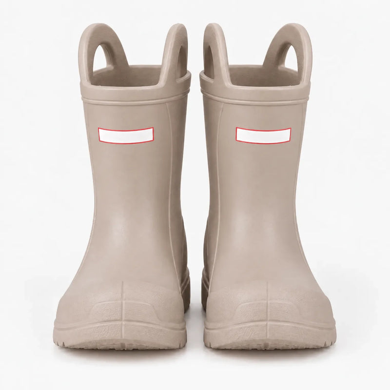 Front view of a pair of beige wellies with pull-on handles and toe caps, studio shot on a white background. 7