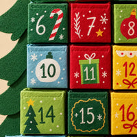 Close-up of the textured felt pockets numbered 6 to 16, printed with candy cane, gift, bauble and snowflake designs. 3