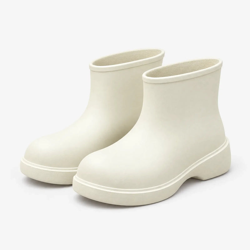 Pair of cream-white ankle boots on a plain background, shown from the front three-quarter angle with the thick sole visible. 5