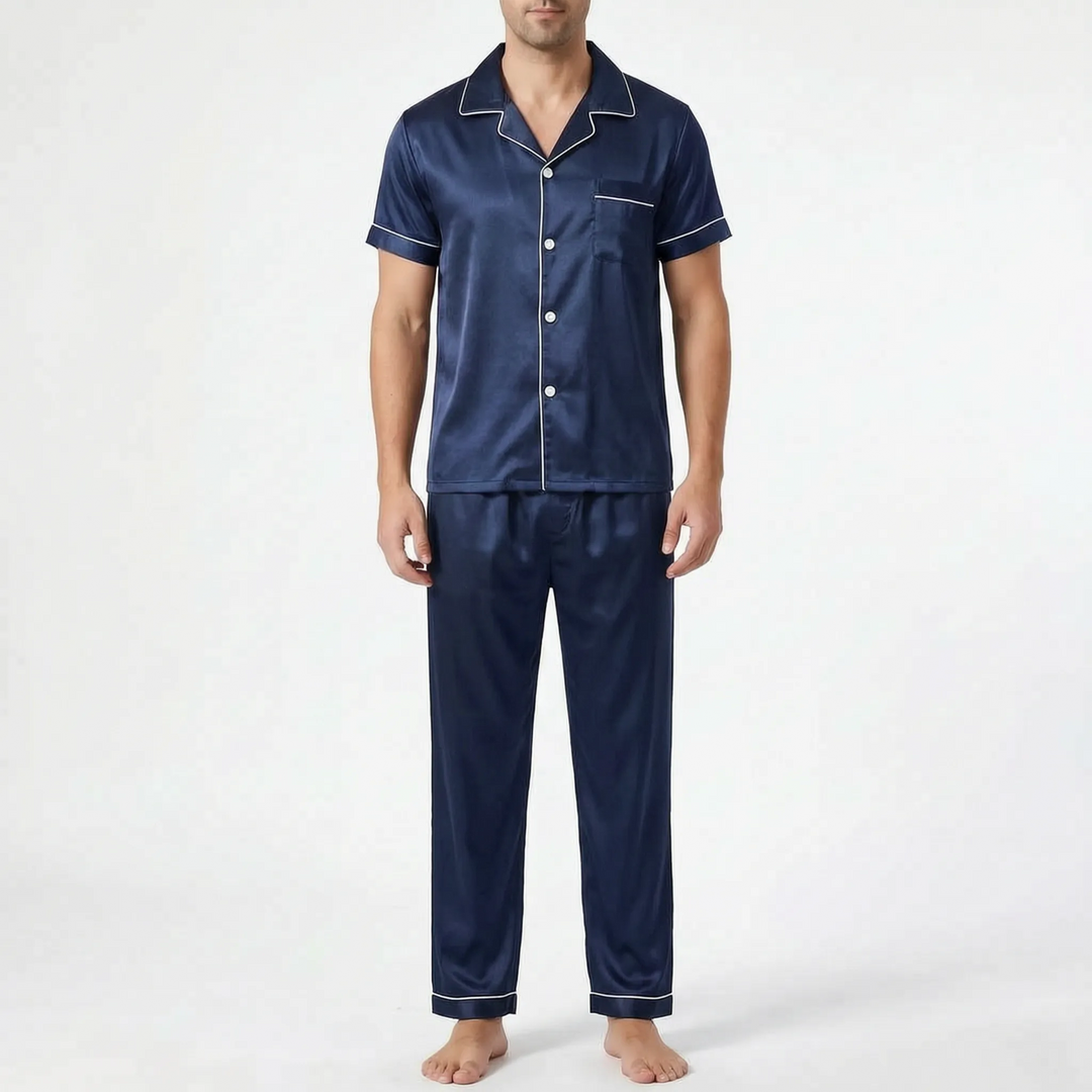 Front view of a model standing in the navy satin pyjama set with white piped collar, sleeves and trouser cuffs. 7