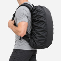 Side view of a man in a grey t-shirt and dark trousers carrying a rucksack under a snug black cover. 4