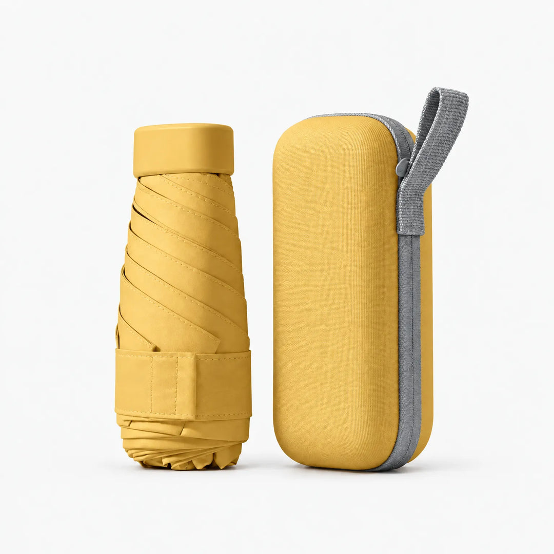 Mustard yellow folded umbrella and matching hard zip case with grey wrist loop, shown on a plain white background. 11