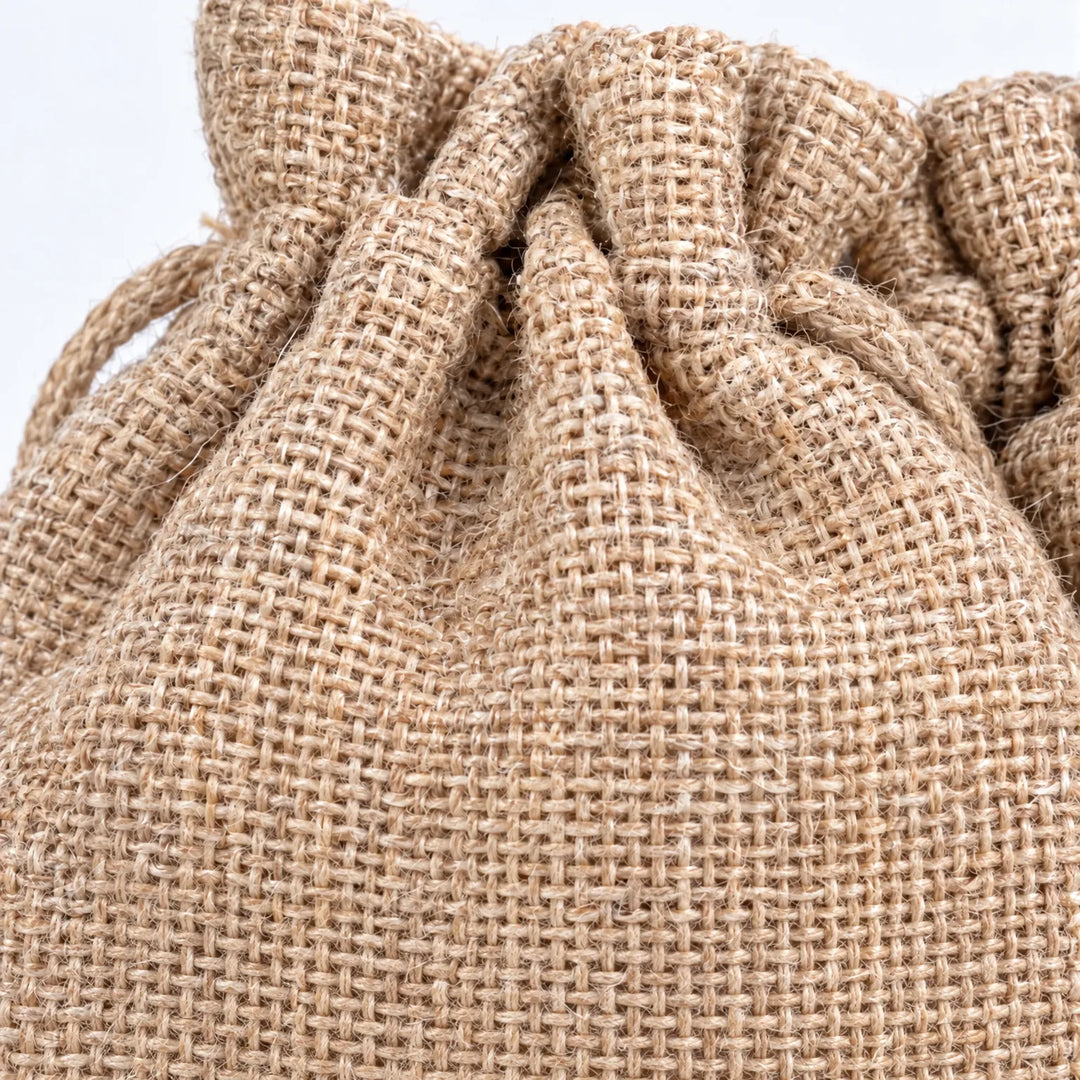 Close-up of the woven burlap texture and gathered drawstring opening of one bag, showing the natural tan fabric weave. 3
