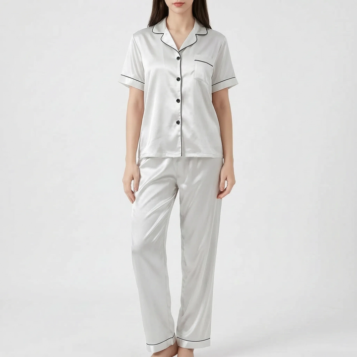 Model wearing the white satin version of the pyjama set with black piping and black buttons. 10