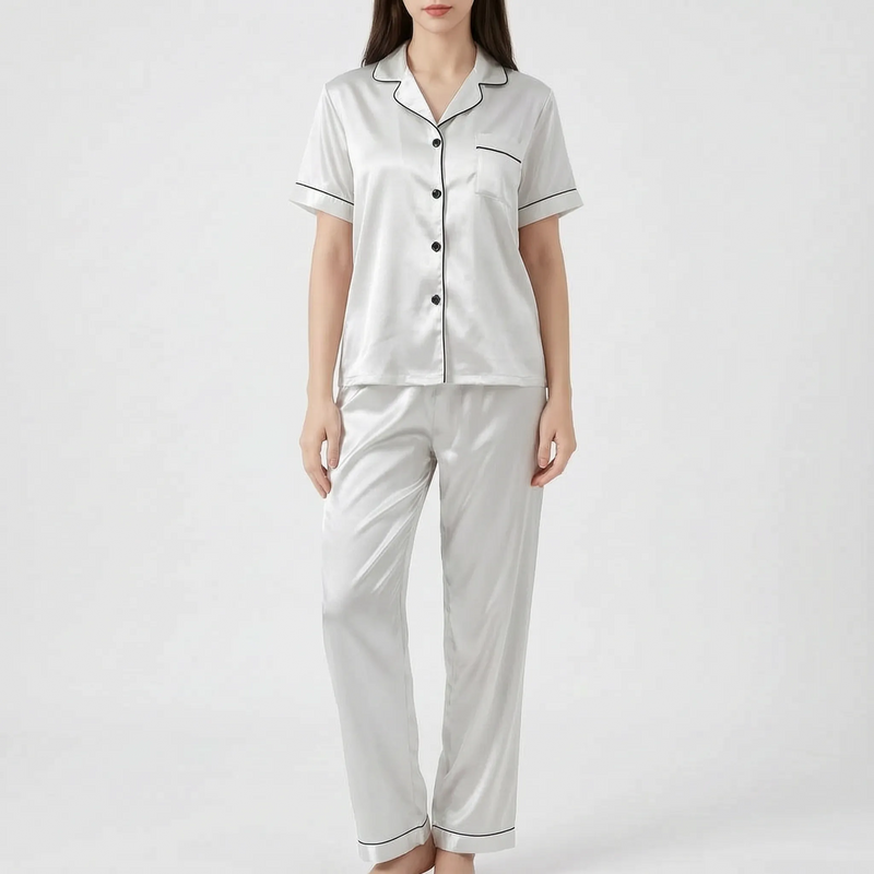 Model wearing the white satin version of the pyjama set with black piping and black buttons. 10