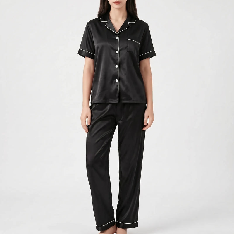 Model wearing the black satin version of the pyjama set with white piping and white buttons. 7