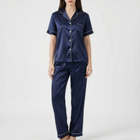 Model wearing the navy blue satin version of the pyjama set with white piping and buttons. 8