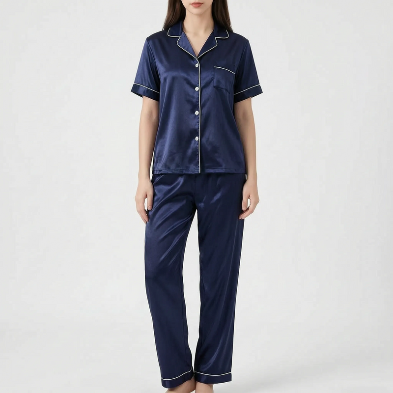 Model wearing the navy blue satin version of the pyjama set with white piping and buttons. 8