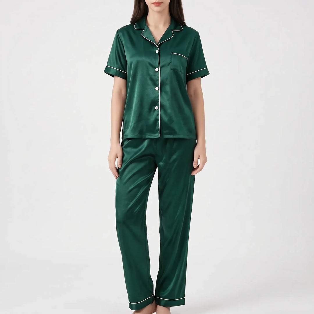 Model wearing the dark green satin version of the pyjama set with white piping and white buttons. 9
