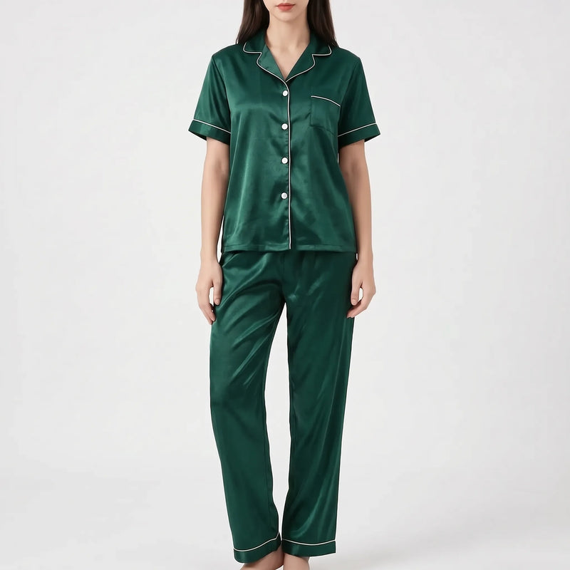Model wearing the dark green satin version of the pyjama set with white piping and white buttons. 9