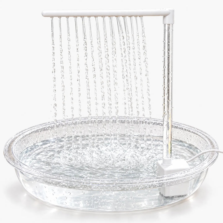 Clear shallow bath with a white pump and overhead bar, rows of water streams falling into the filled dish against a plain white background. 1