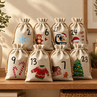 Eight natural linen drawstring bags with jute cords, printed with numbers and festive designs, stacked on a wooden shelf in a cosy setting. 1