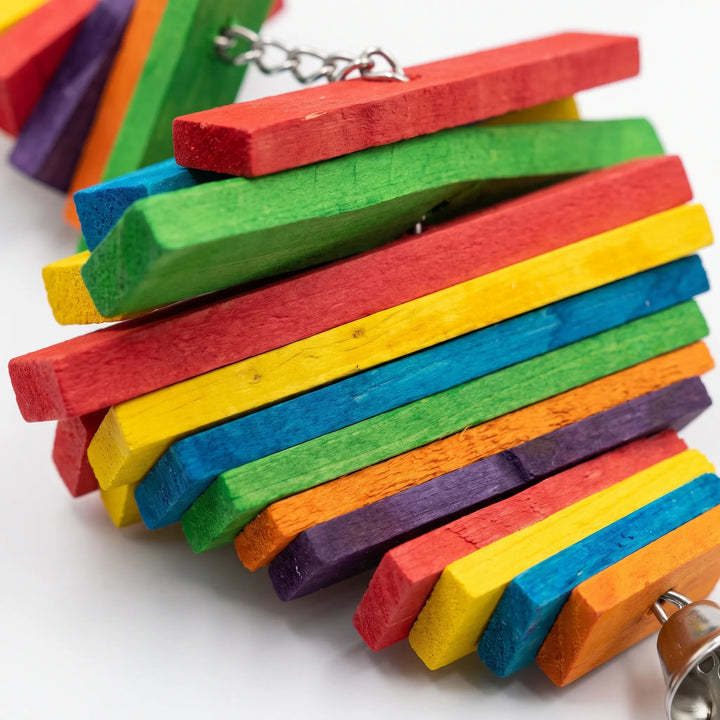 Close-up of the dyed wooden slats in red, green, yellow, blue, orange and purple, with a metal chain and bell visible. 3