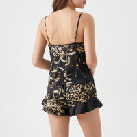 Back view of the black floral cami set on a model, showing thin straps and the printed back panel. 3