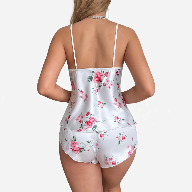 Back view of the set on a model, showing thin straps, the open back of the cami and rose print shorts. 3