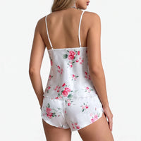 Back view of the white satin rose-print set, showing thin straps, the plain back of the cami and the shorts. 3
