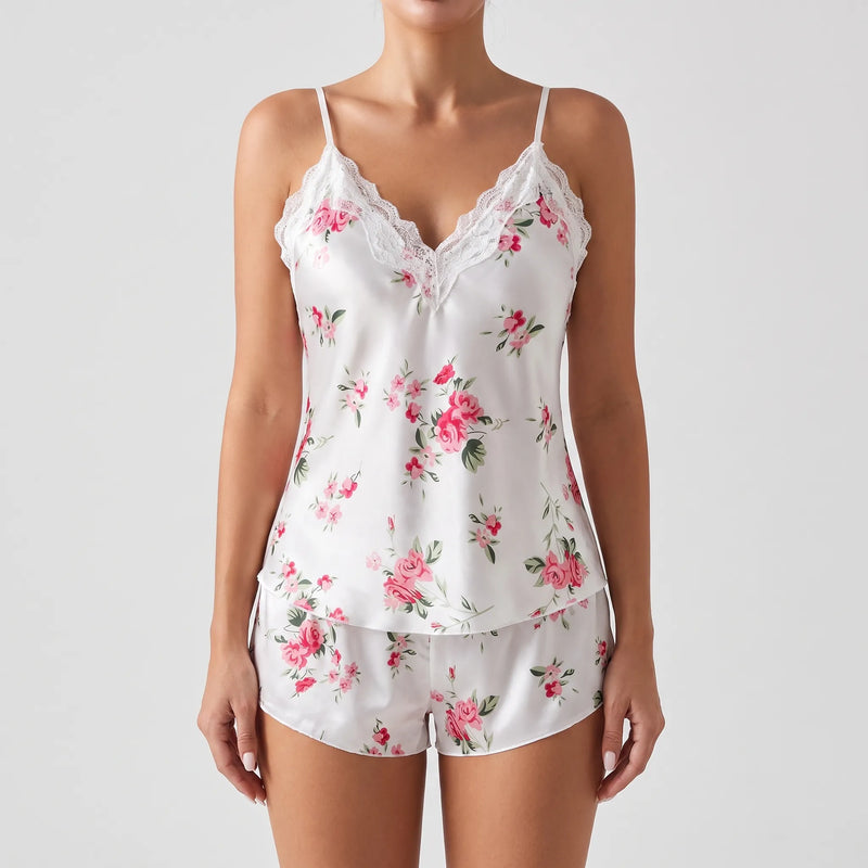 Front view of a model wearing the white satin lace-trimmed cami and matching floral shorts against a plain grey background. 6