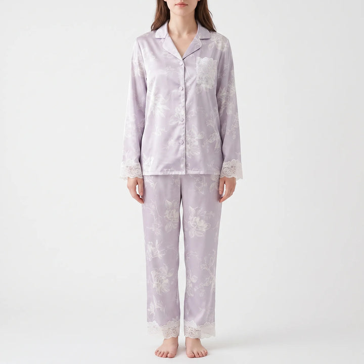 Second front view of the model in the lilac floral pyjamas, showing the lace pocket, lace cuffs, and lace trouser hems. 4