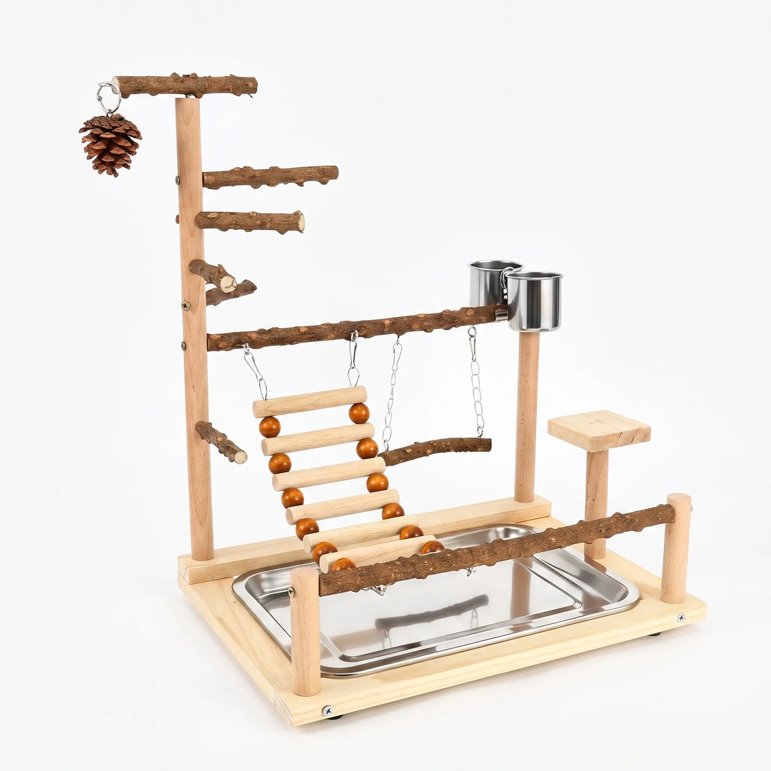 Wooden bird play stand on a plain white background, with natural branch perches, rope-bead ladder, swing, steel cups, pine cone and tray. 1