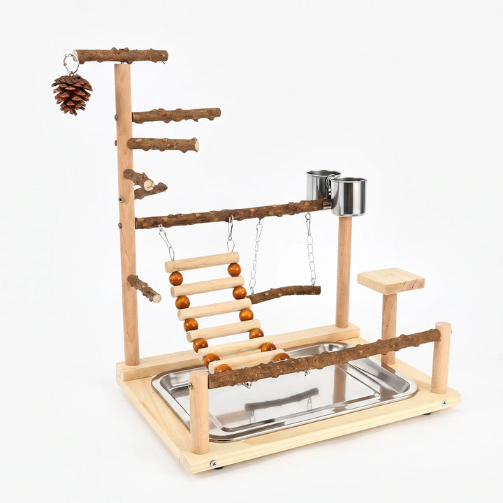 Wooden bird play stand on a plain white background, with natural branch perches, rope-bead ladder, swing, steel cups, pine cone and tray. 1