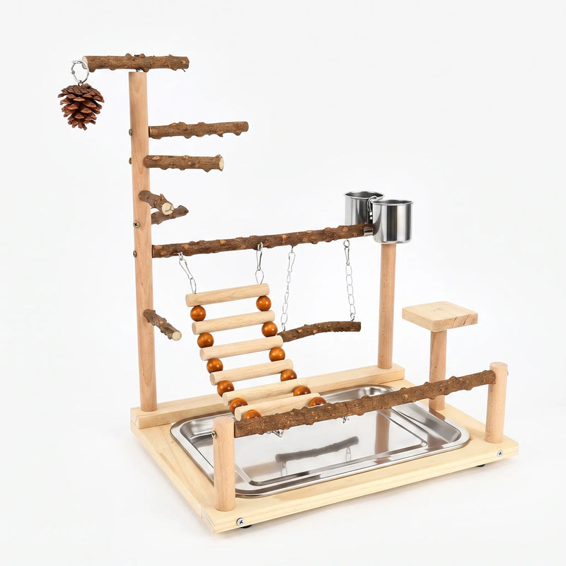 Wooden bird play stand on a plain white background, with natural branch perches, rope-bead ladder, swing, steel cups, pine cone and tray. 1