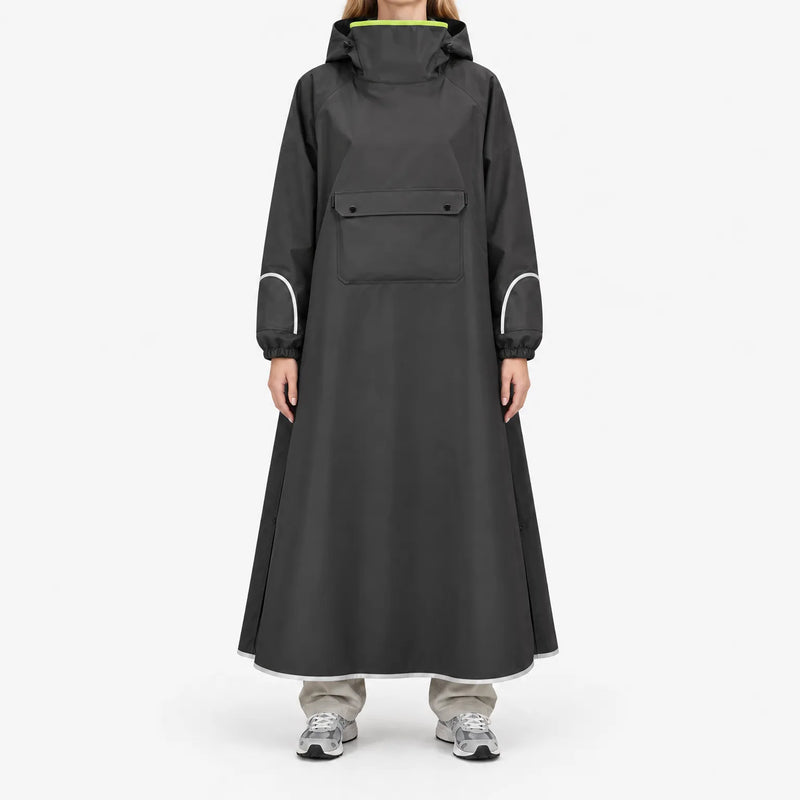 Front view of a model in the black version of the long poncho, with chest flap pocket, reflective sleeve and hem trim, and neon lime collar lining. 4