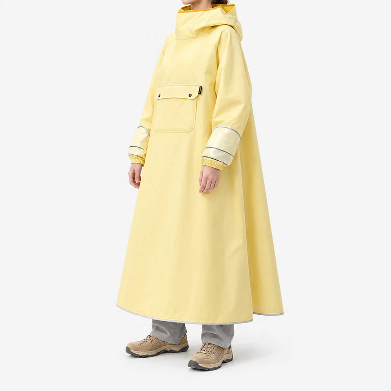 Three-quarter side view of the yellow poncho on a model, showing its wide A-line drape, translucent sleeve panels with reflective stripes, and chest pocket. 5