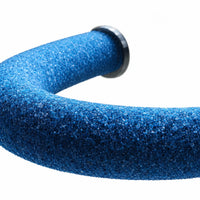 Close-up of the blue sand-coated surface of the curved perch, showing its coarse grit and a dark end washer. 4
