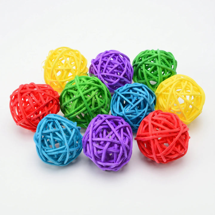 Ten woven rattan balls in yellow, purple, green, red and blue, grouped together on a plain white background. 1