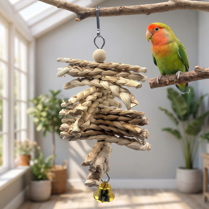 Toy hung from a branch in a bright room, with a green and orange lovebird perched on a twig beside it. 2