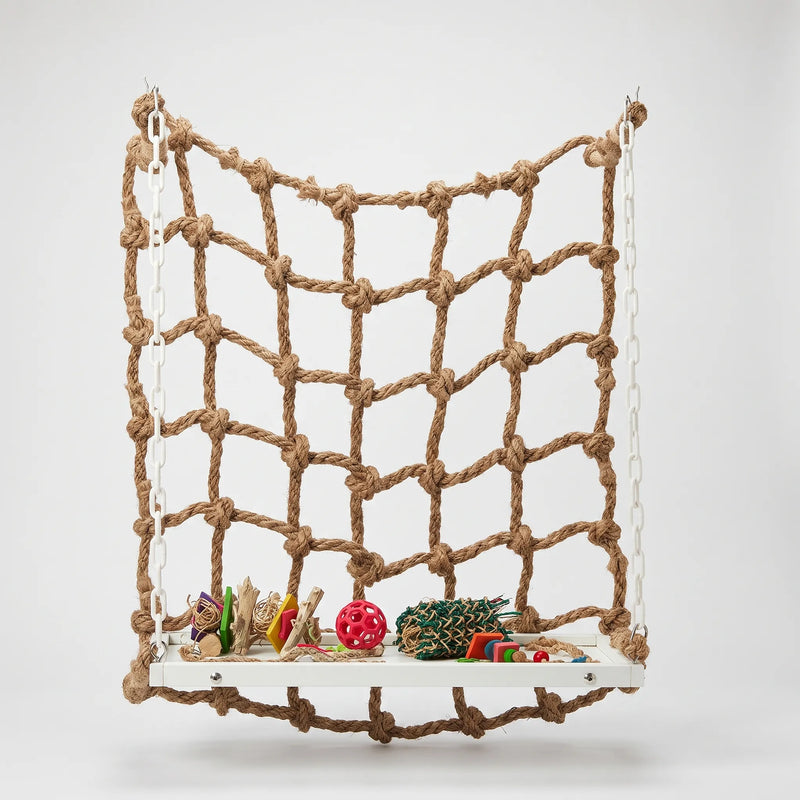Natural rope climbing net hung by white plastic chains above a white platform holding colourful toys, shown against a plain background. 1