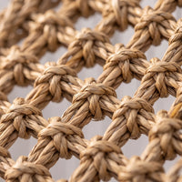 Close-up of the twisted, knotted natural fibre weave, showing the texture of the knots and the open gaps between them. 3
