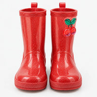 Front view of red glitter rain boots with pull-on loops and a glossy cherry charm on the shaft. 2