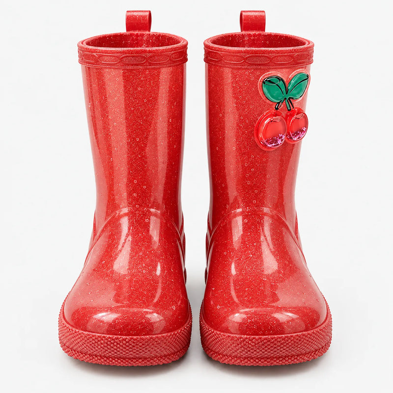 Front view of red glitter rain boots with pull-on loops and a glossy cherry charm on the shaft. 2