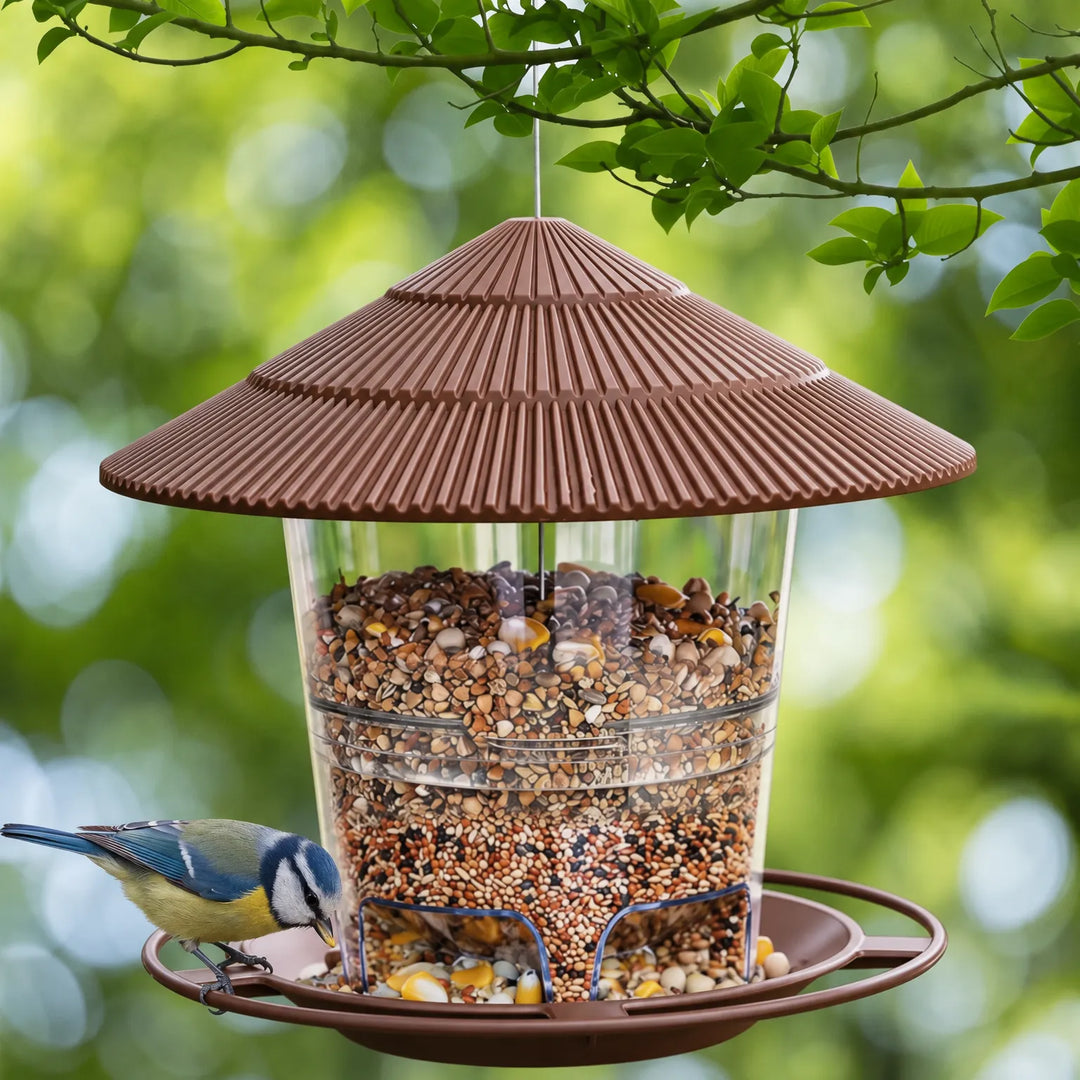 Brown feeder filled with mixed seed hanging from a branch, with a blue tit perched on the tray, green foliage behind. 2