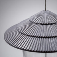Close-up of the grey tiered, ribbed roof, showing its fine radial ridges and the steel cable passing through the top. 3