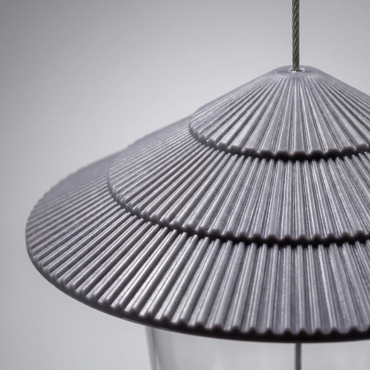 Close-up of the grey tiered, ribbed roof, showing its fine radial ridges and the steel cable passing through the top. 3
