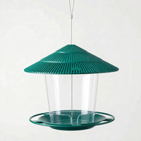 Dark green version hanging empty on a steel wire, with ribbed tiered roof, clear seed container and ring-edged feeding tray. 6
