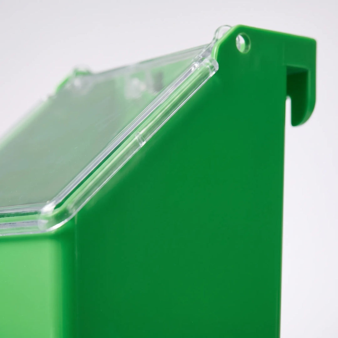 Close-up of the feeder's side, showing the hook at the top for hanging on cage bars and the clear lid edge. 3