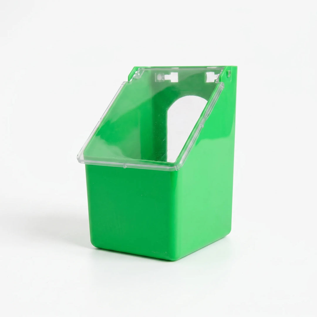 Single-compartment feeder seen from a three-quarter angle against a white background, with its clear hinged lid closed and the arched opening visible behind it. 4