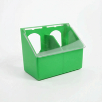Wider two-compartment version of the green feeder with a central divider and two arched openings under the clear lid. 5