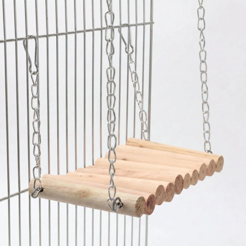 Wooden rope-style bridge of natural dowels on metal chains, clipped by hooks to the bars of a silver cage. 1