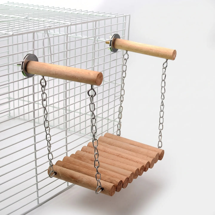 Plain wooden dowel bridge on chains, suspended from two perches fixed to the side of a white wire cage. 5