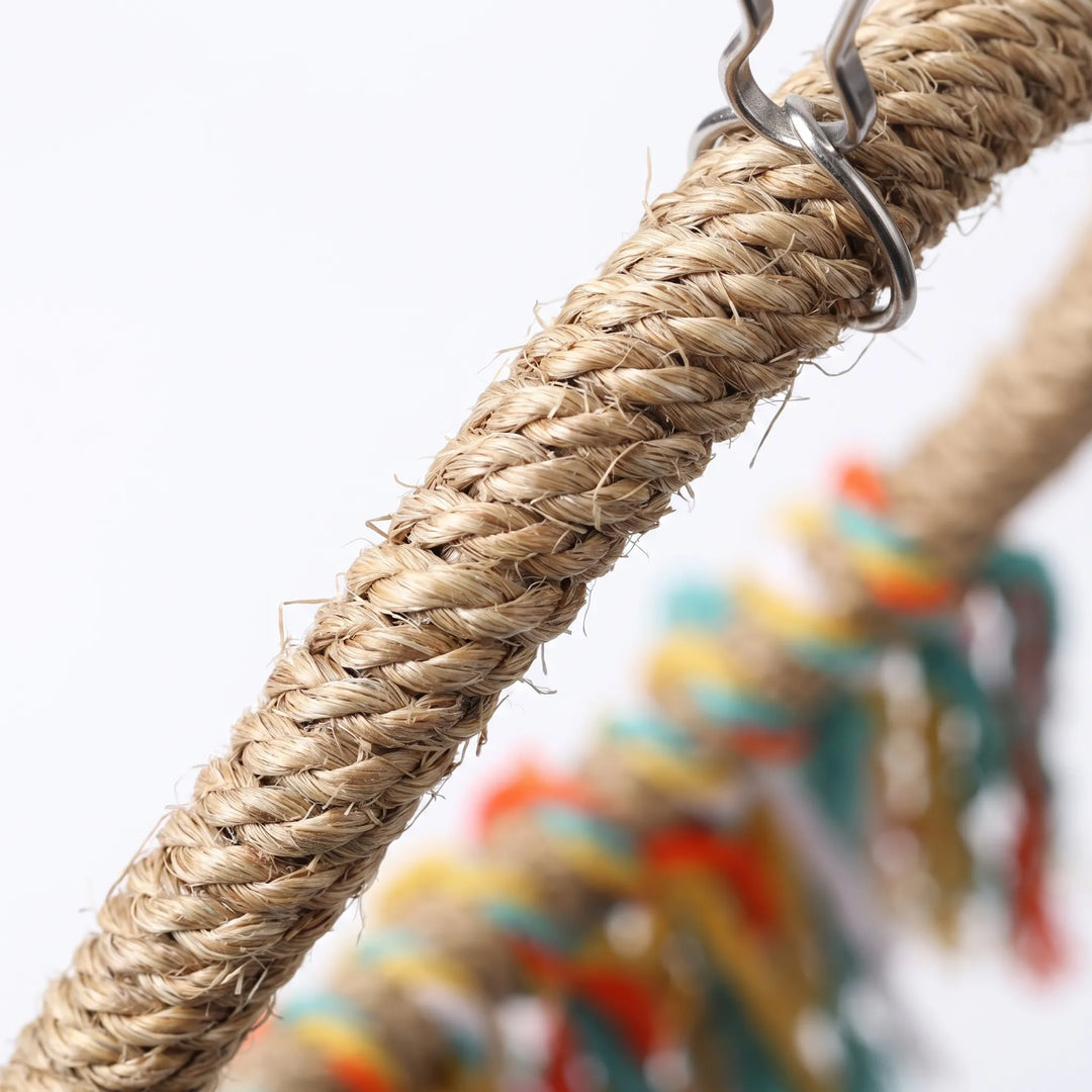 Close-up of the twisted natural fibre rope and the metal clip fixing, with the coloured fringe blurred behind. 3