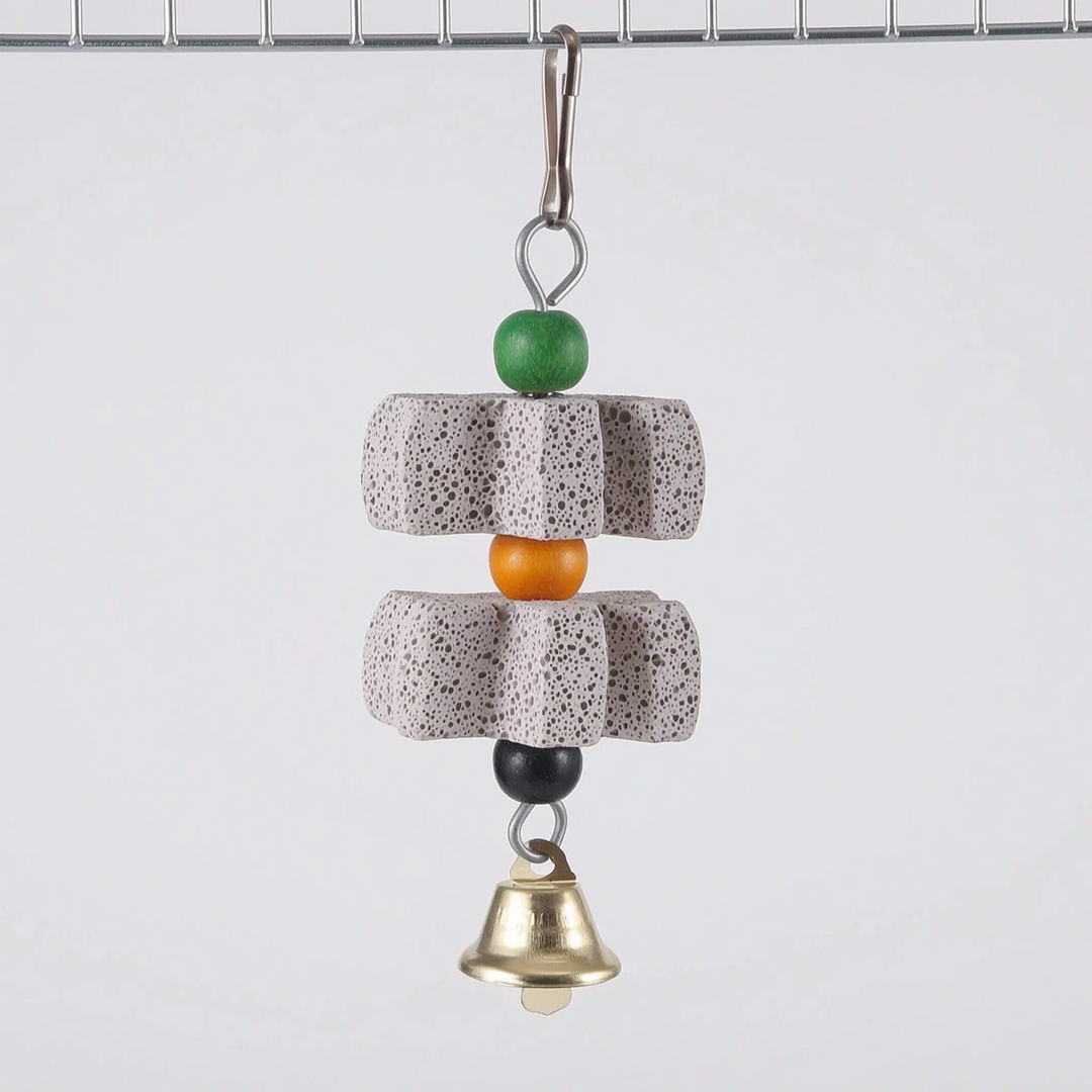 Version with two star-shaped grey stone blocks separated by an orange bead, with green and black beads and a bell, hung from cage wire. 6