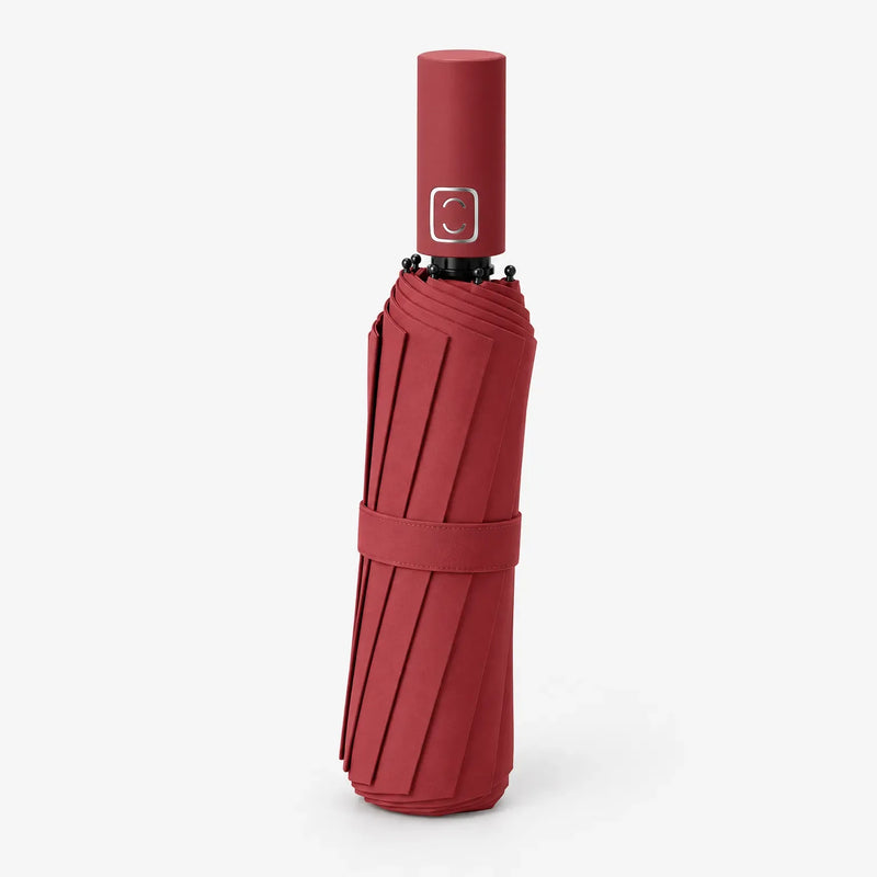 Folded red umbrella with a matching strap, shown at an angle against a white background with the handle on top. 4