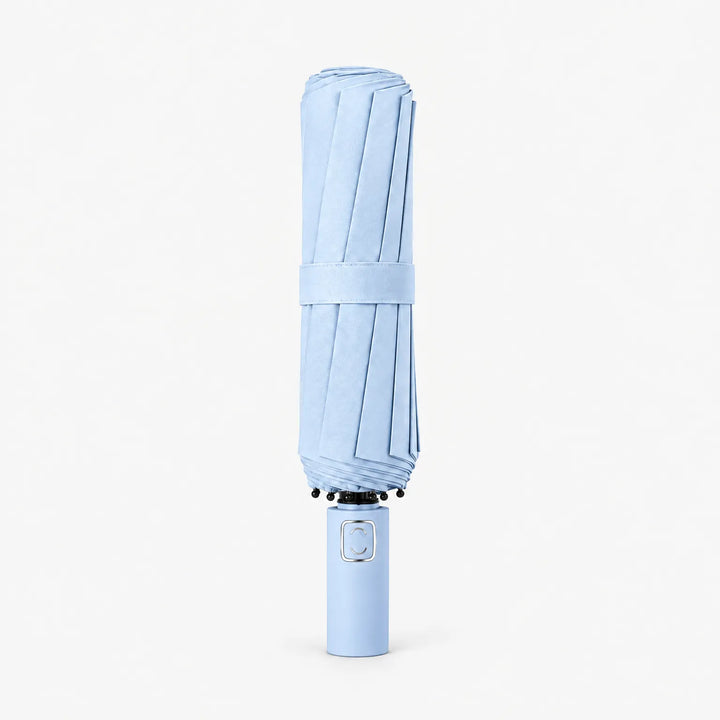 Folded light blue umbrella standing upright on a white background, held closed by a fabric strap. 6