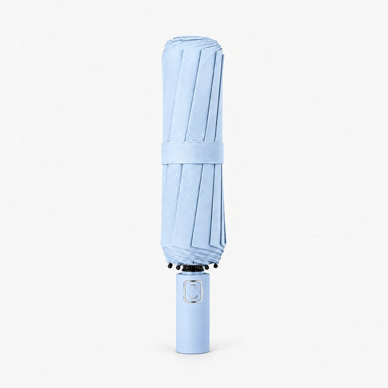 Folded light blue umbrella standing upright on a white background, held closed by a fabric strap. 6