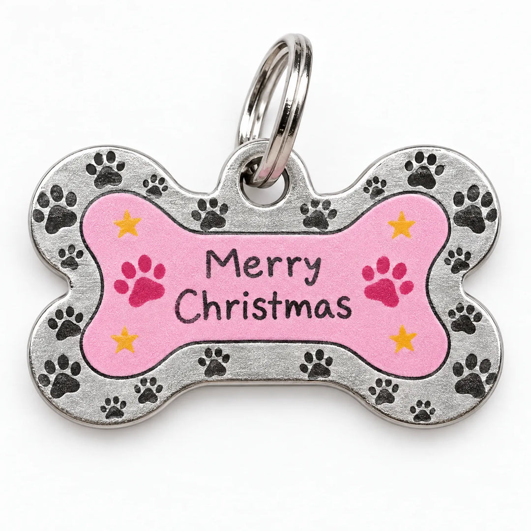 Close-up of a bone-shaped metal pet tag with a pink center, paw-print border, small yellow stars and a split ring. 3